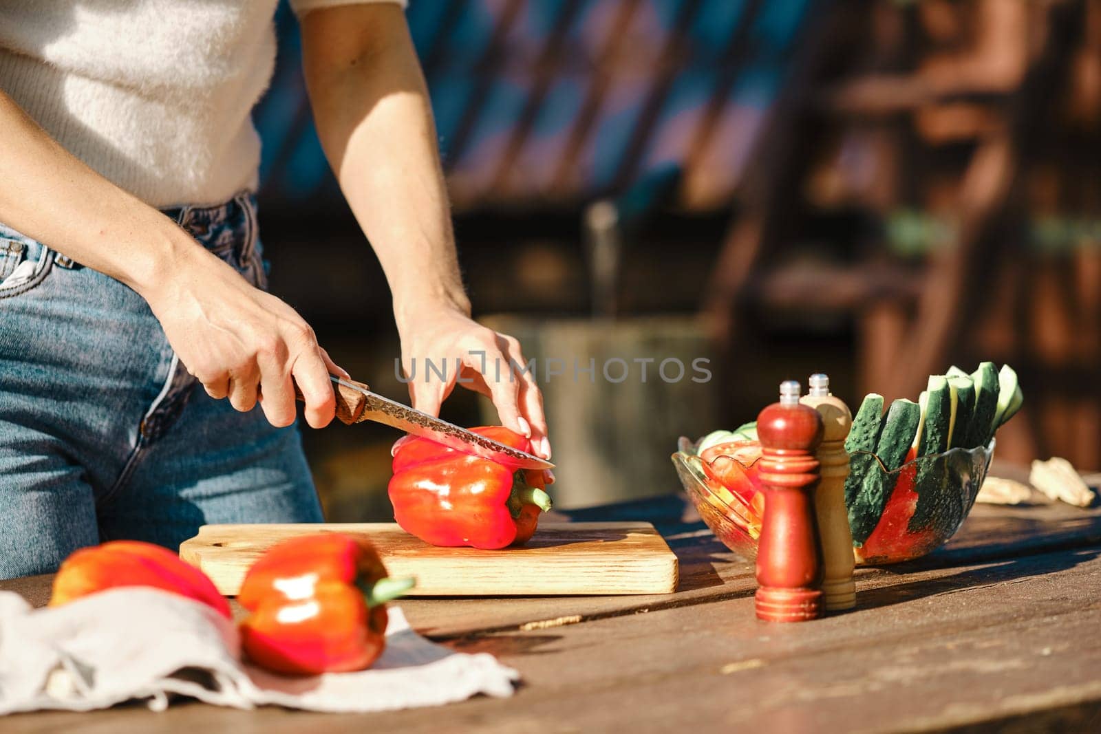 Closeup view of cutting fresh bell pepper for picnic