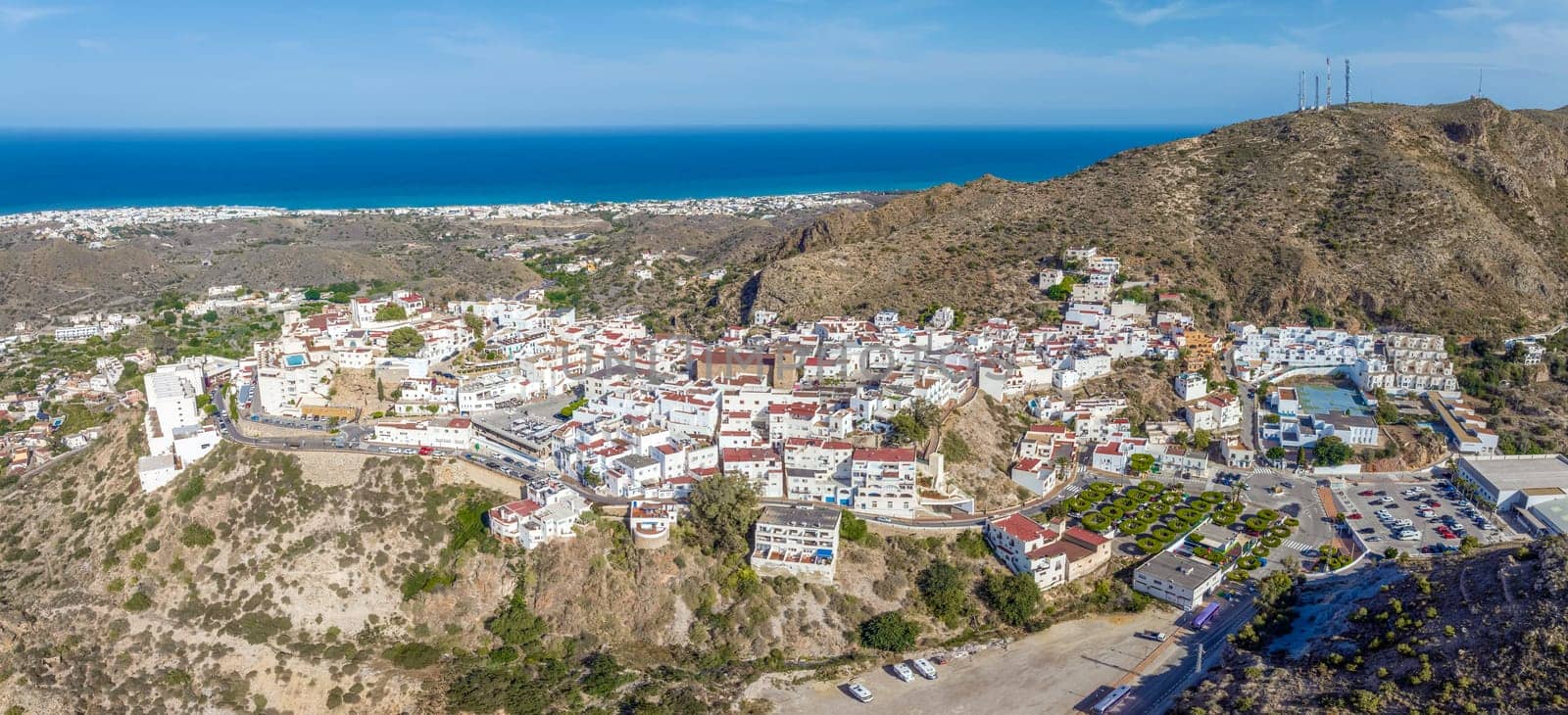 Picturesque spanish hillside white washed village of Mojacar during sunny day against blue sky. Travel destinations, famous places. Europe, southern Spain great panoramic view