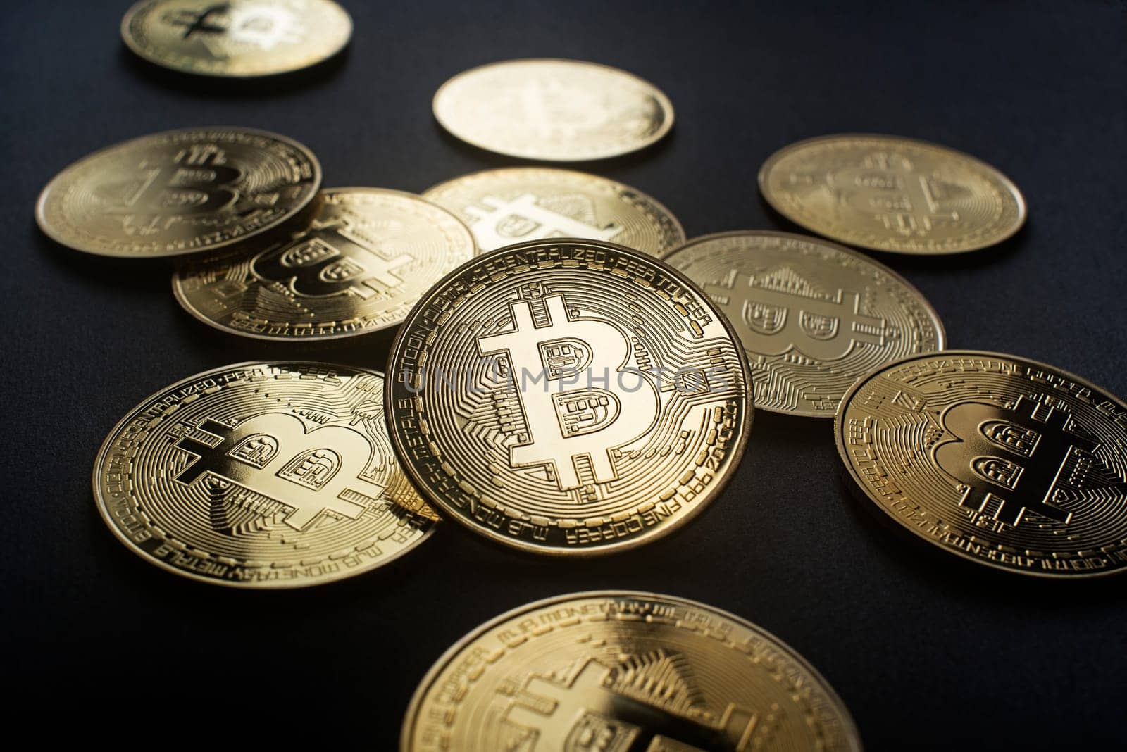 Bitcoin and cryptocurrency investing concept. Bitcoin cryptocurrency symbol with coins on black background. Trading on the cryptocurrency exchange.