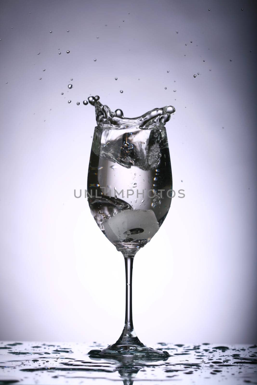 alcohol splash on the gray background close up
