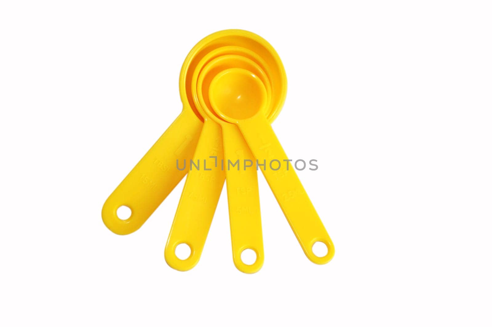 A set of four measuring spoons, made of yellow plastic, arranged to illustrate the progression of size. Measurements are visible on each spoon.