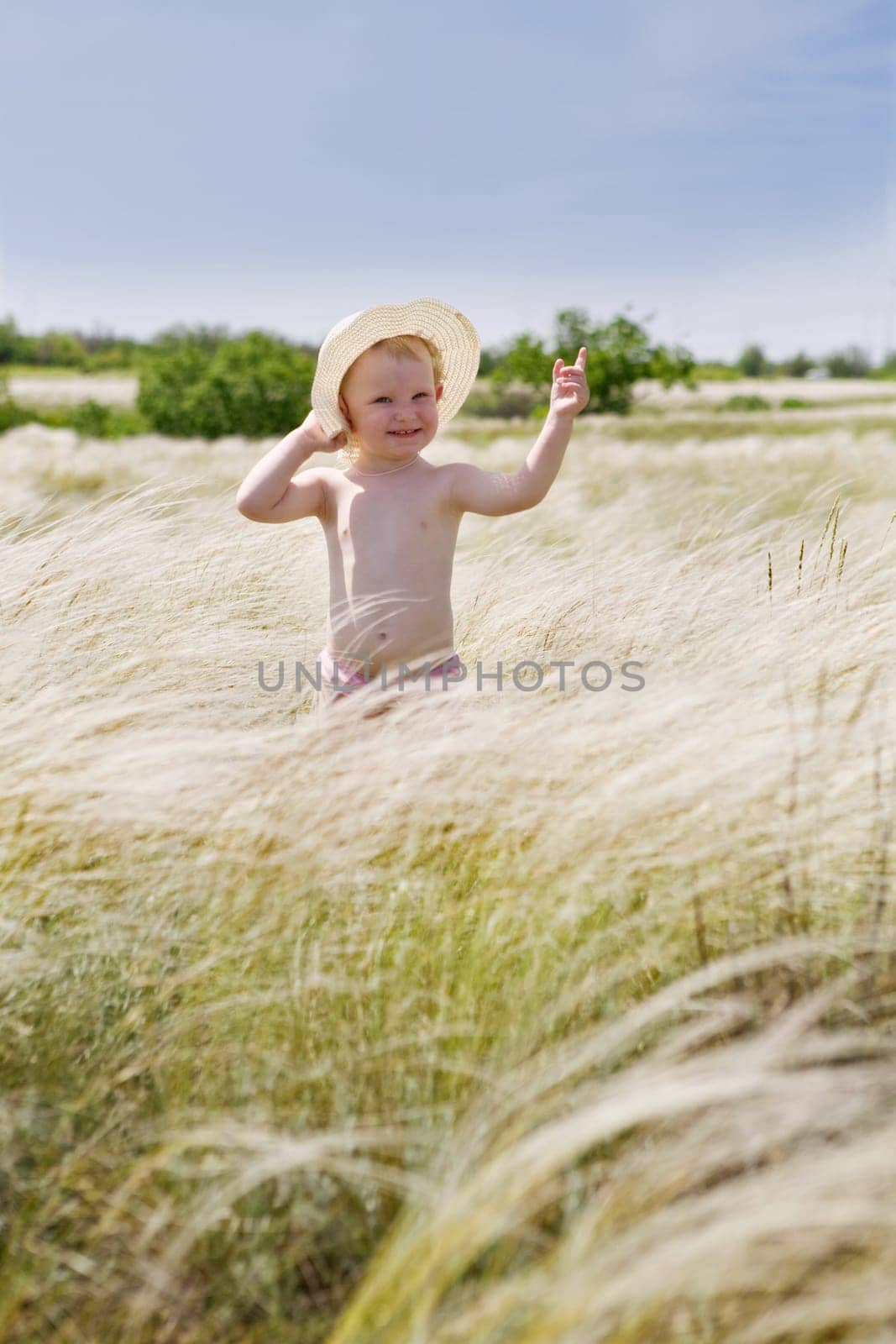 small girl in feather-grass