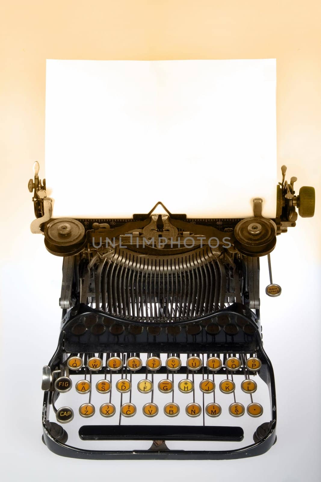 Vintage retro typewriter with blank white sheet on gradient background