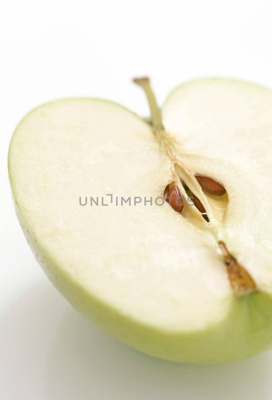 Half of green apple on white background