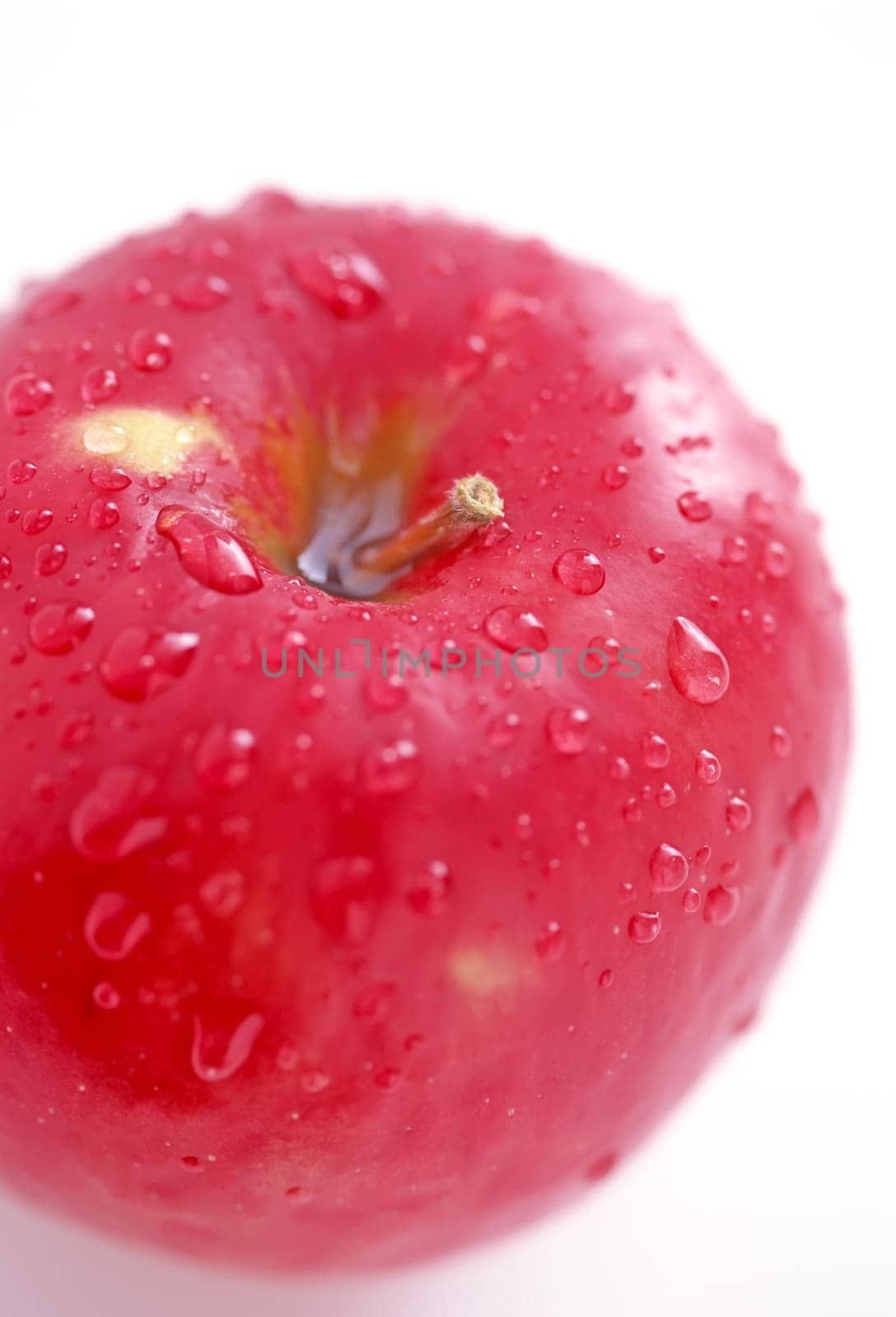 Red apple with waterdrops on a white background