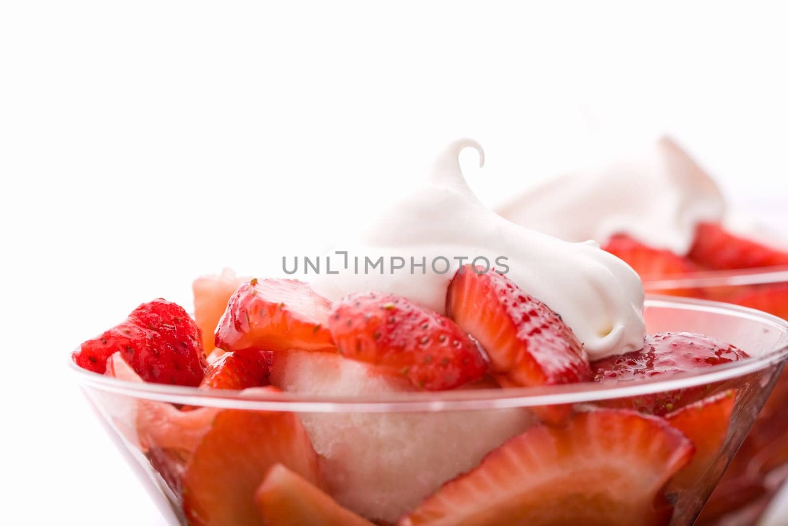 Strawberry shortcake in a martini glass sponge cake and whip cream
