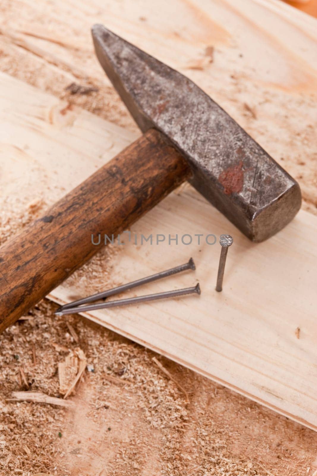 tools series: hammer and nails on the wooden plank