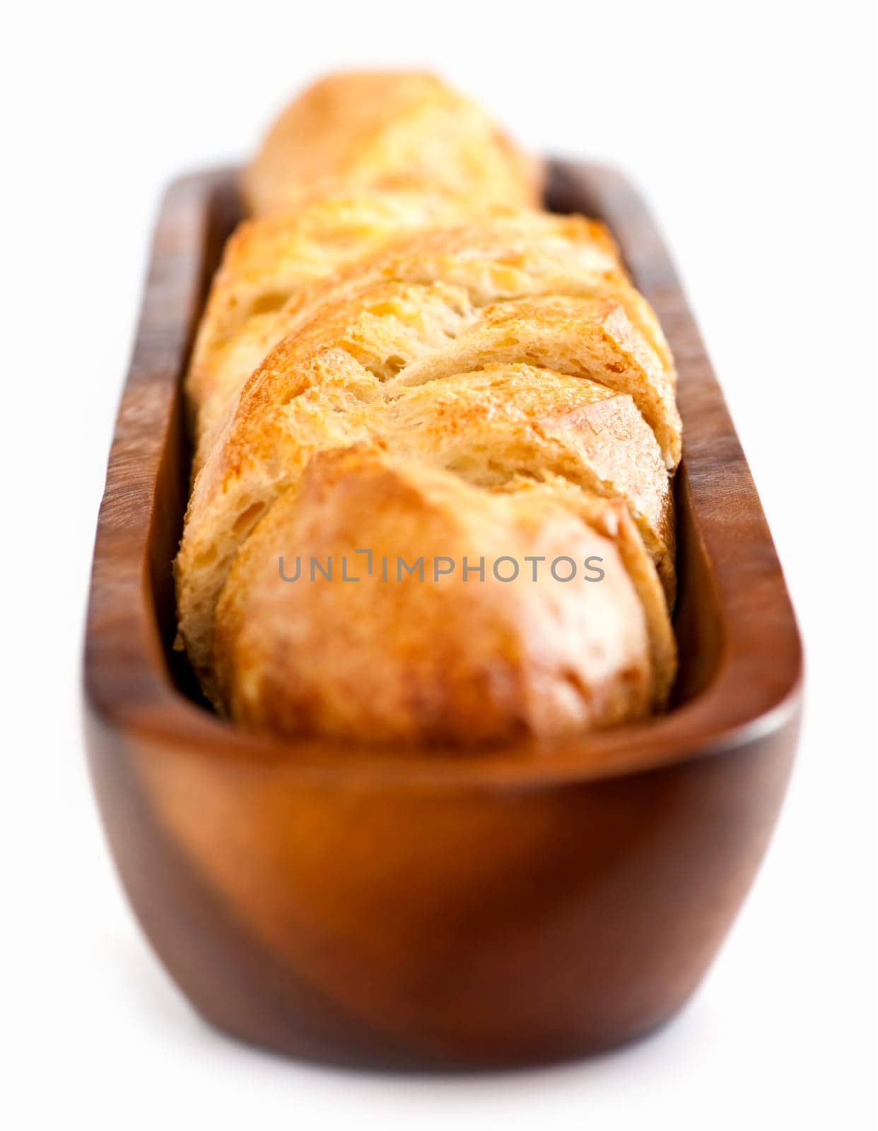 Isolated sliced baguette bread in wooden dish