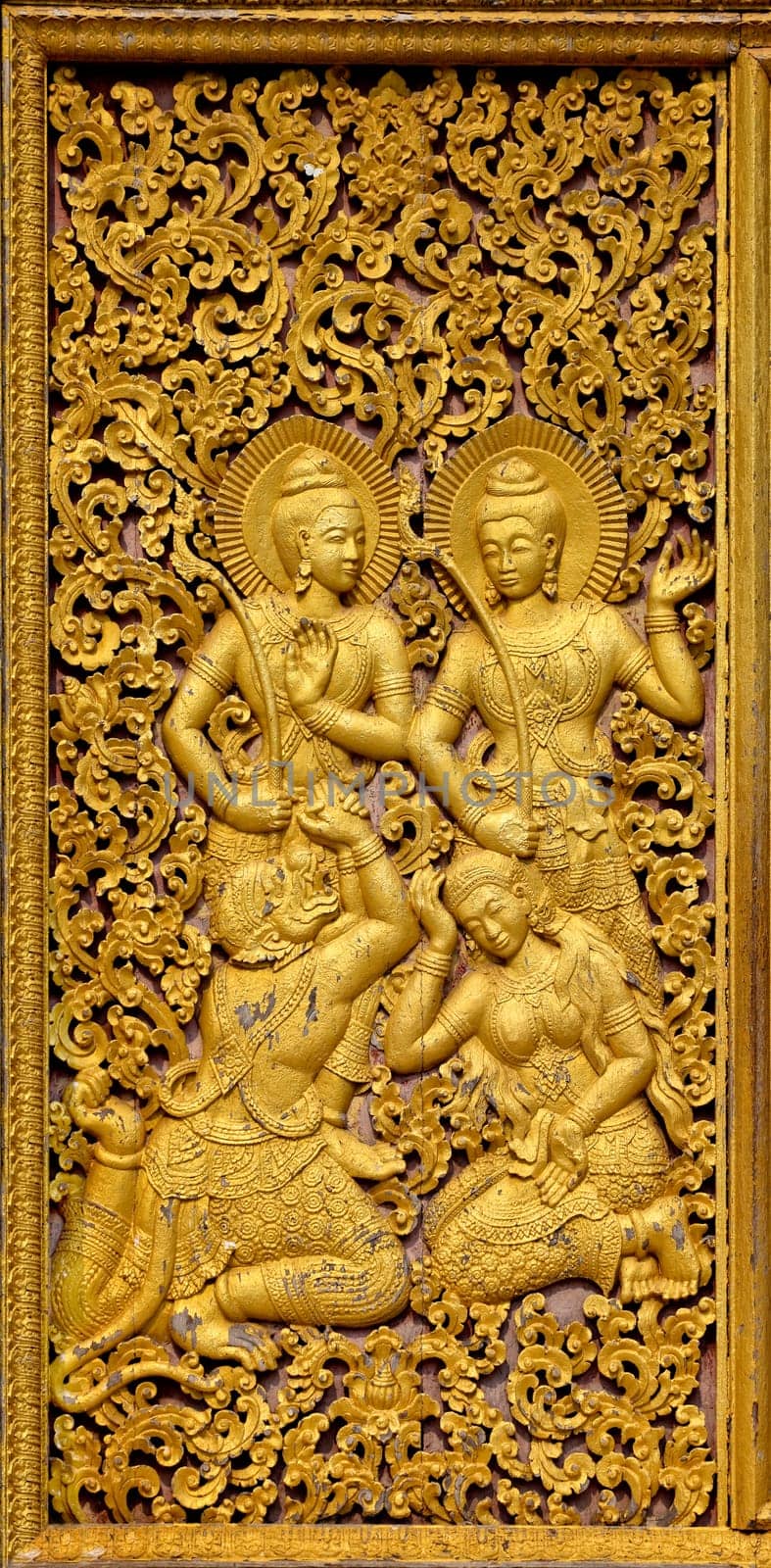 a golden frame with 4 budhist figures and ornaments