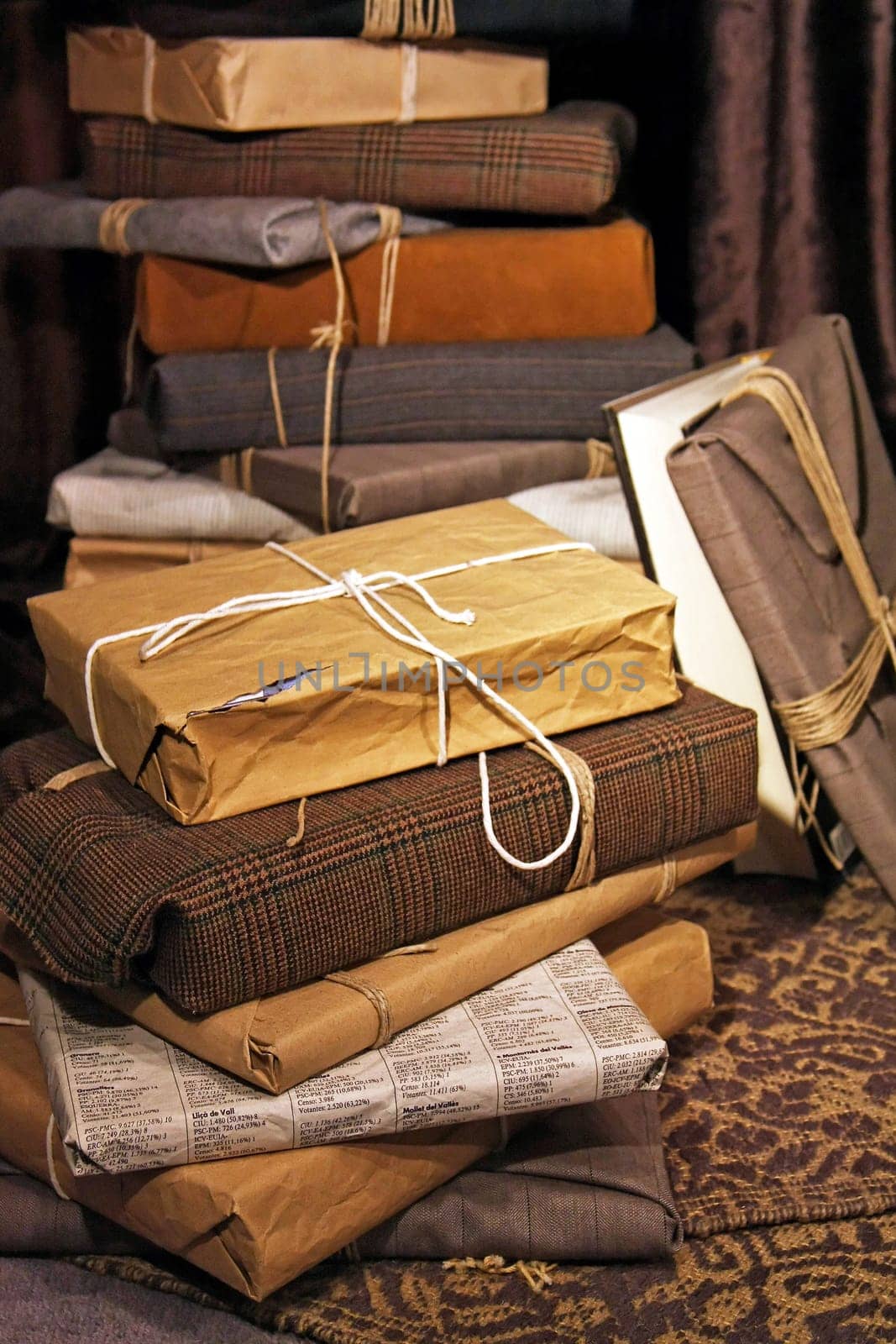 Big stack of gifts wrapped in recycled paper