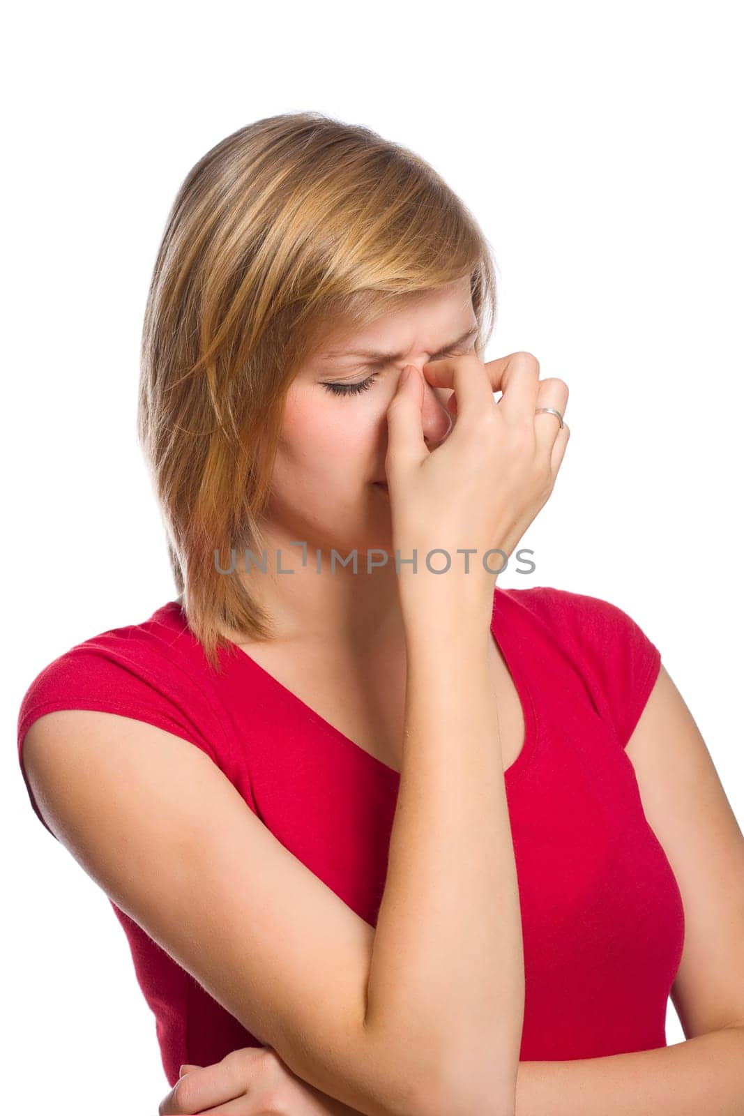 beautiful blonde female in red shirt is having a headache isolated on white