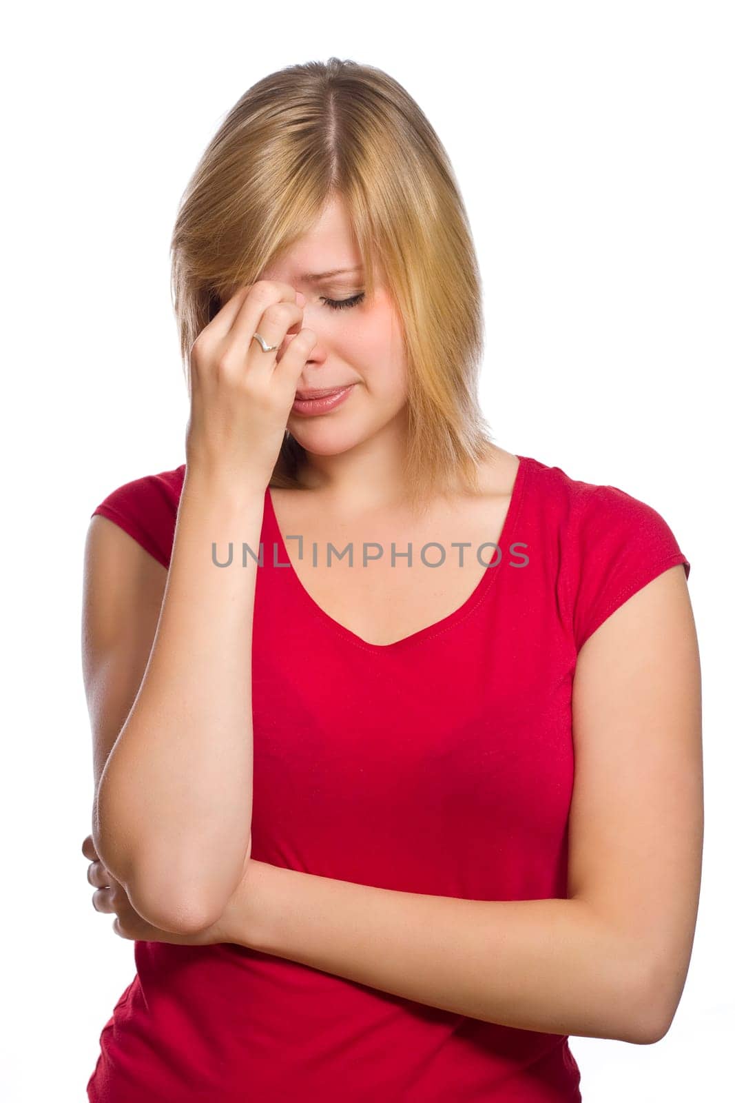 beautiful blonde female in red shirt is having a headache isolated on white