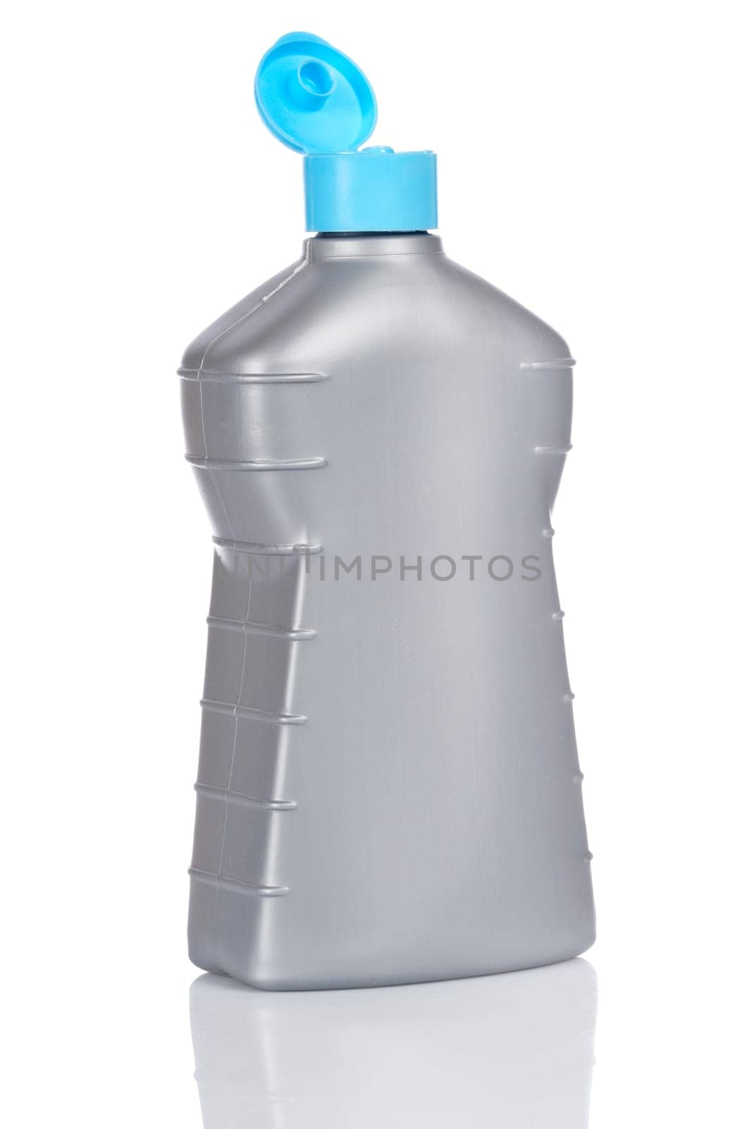 Opened plastic detergent bottle reflected on white background