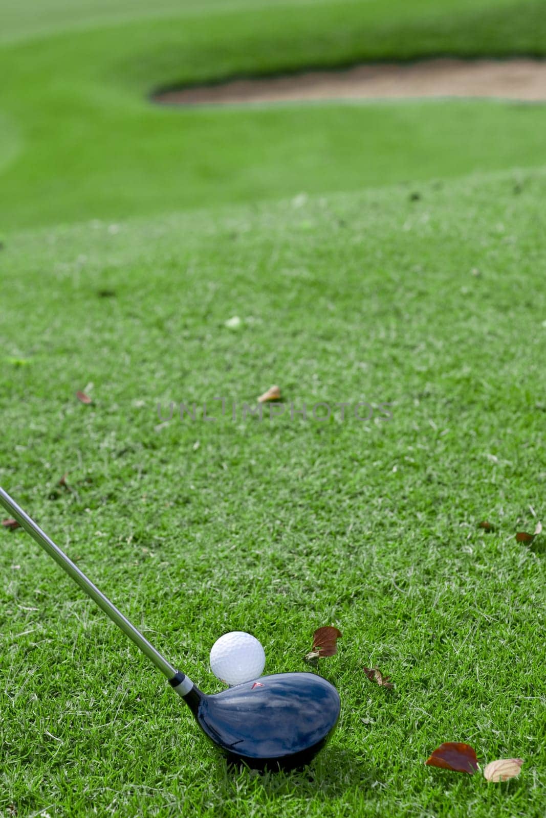 getting ready to hit golf ball of a small hill