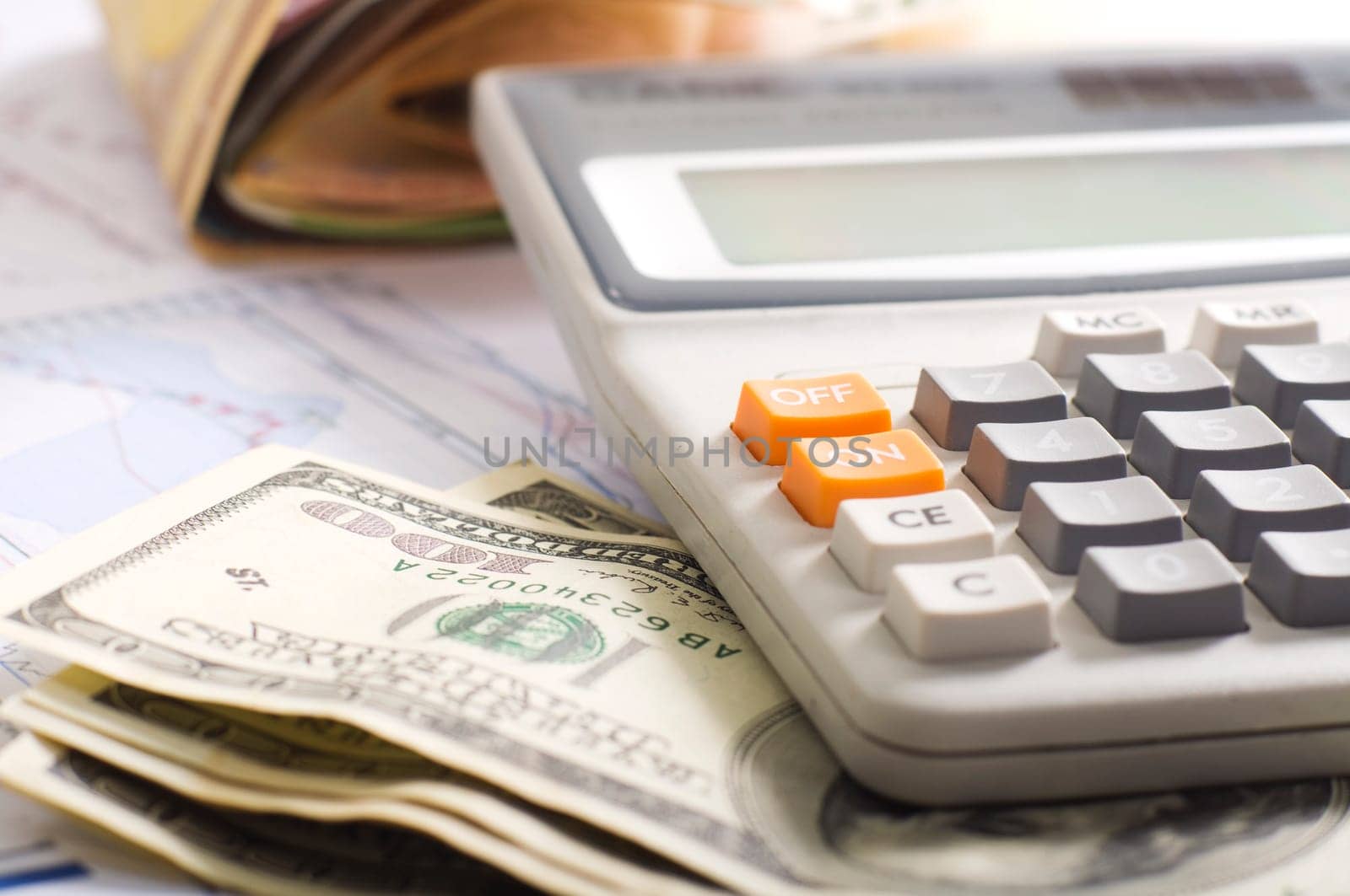 news papers with dollars and a pocket calculator