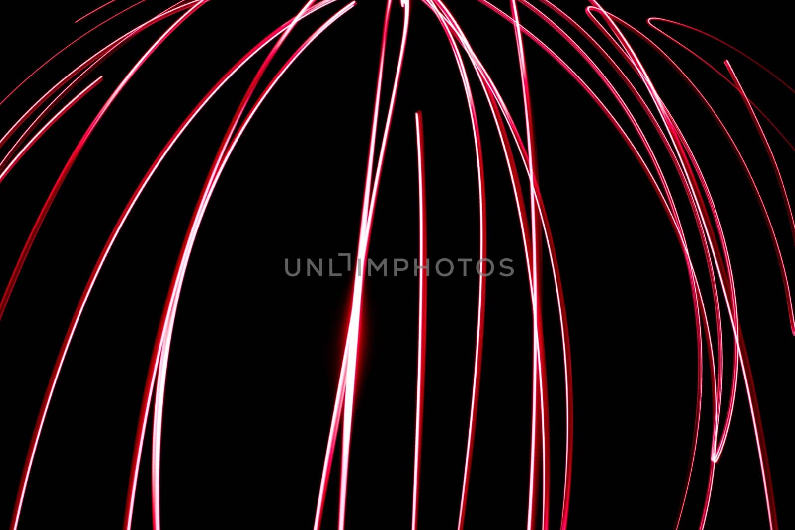 An abstract light background showing motion blurred light on a dark background.