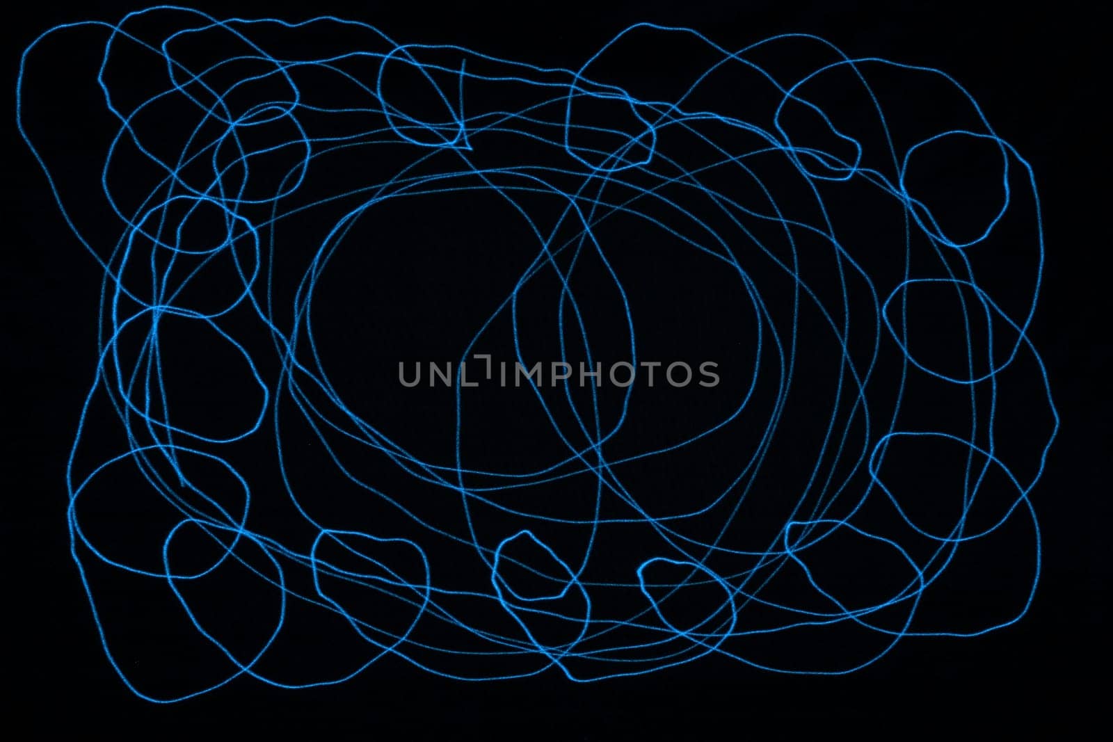 An abstract light background showing motion blurred light on a dark background.