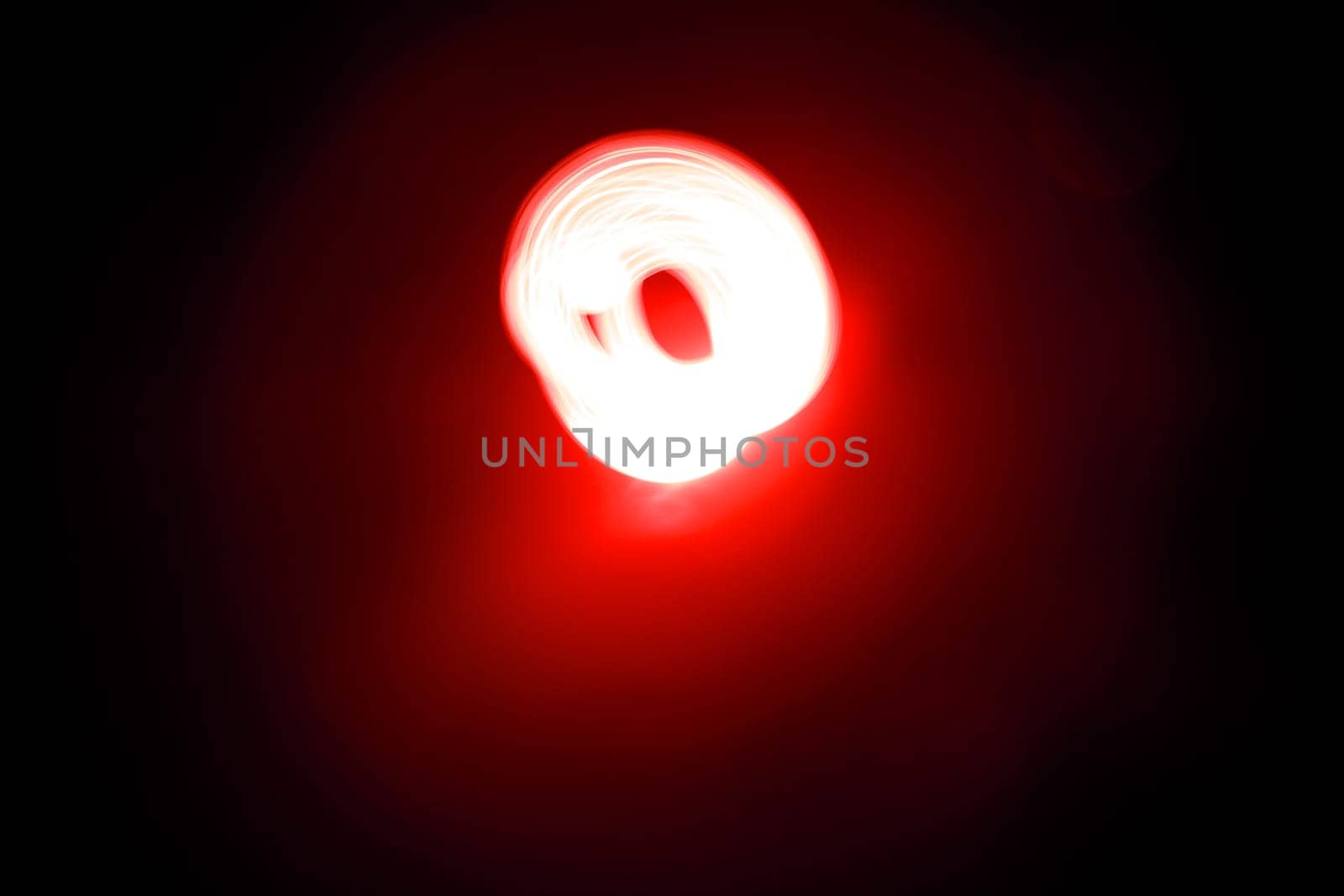 An abstract light background showing motion blurred light on a dark background.