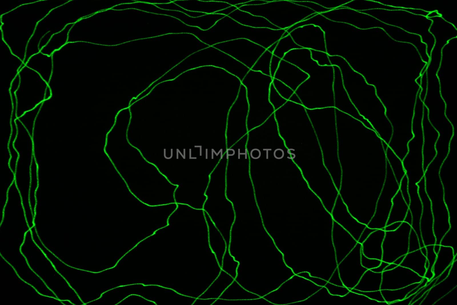 An abstract light background showing motion blurred light on a dark background.