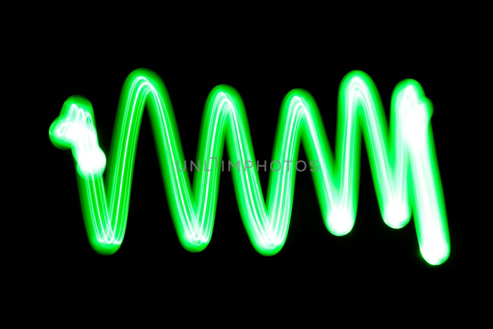 An abstract light background showing motion blurred light on a dark background.