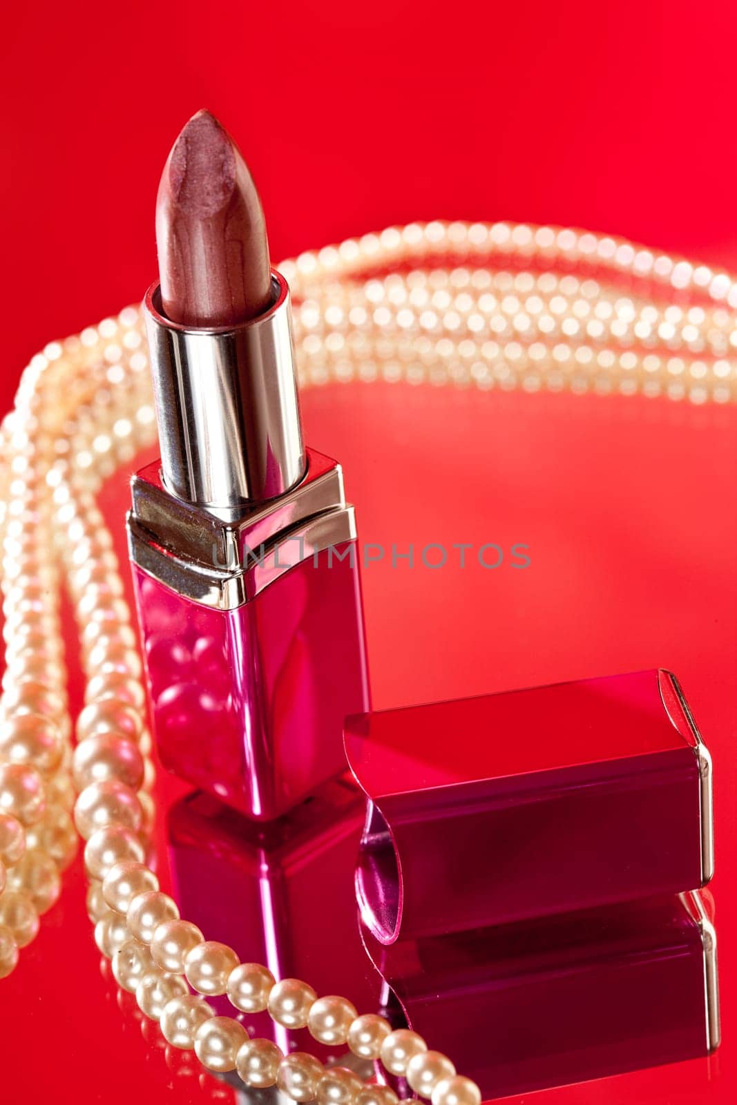 make up object: lipstick over red background