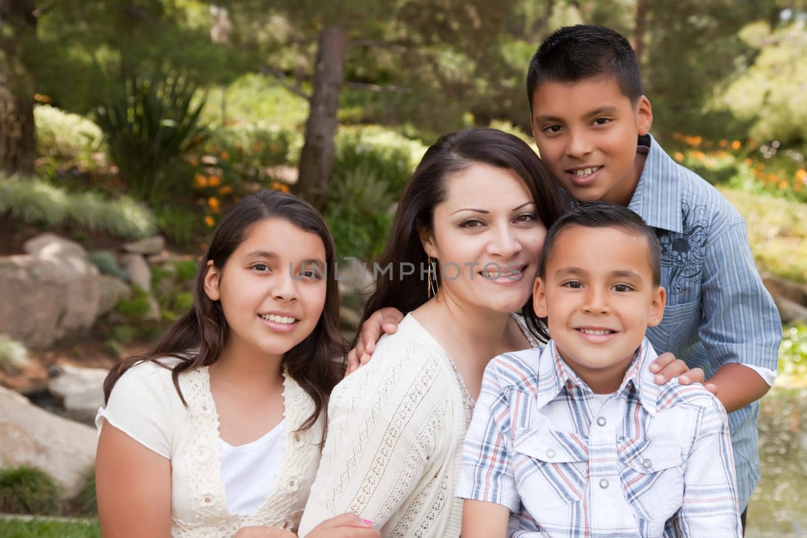 Happy Hispanic Mother and Children in the Park.
