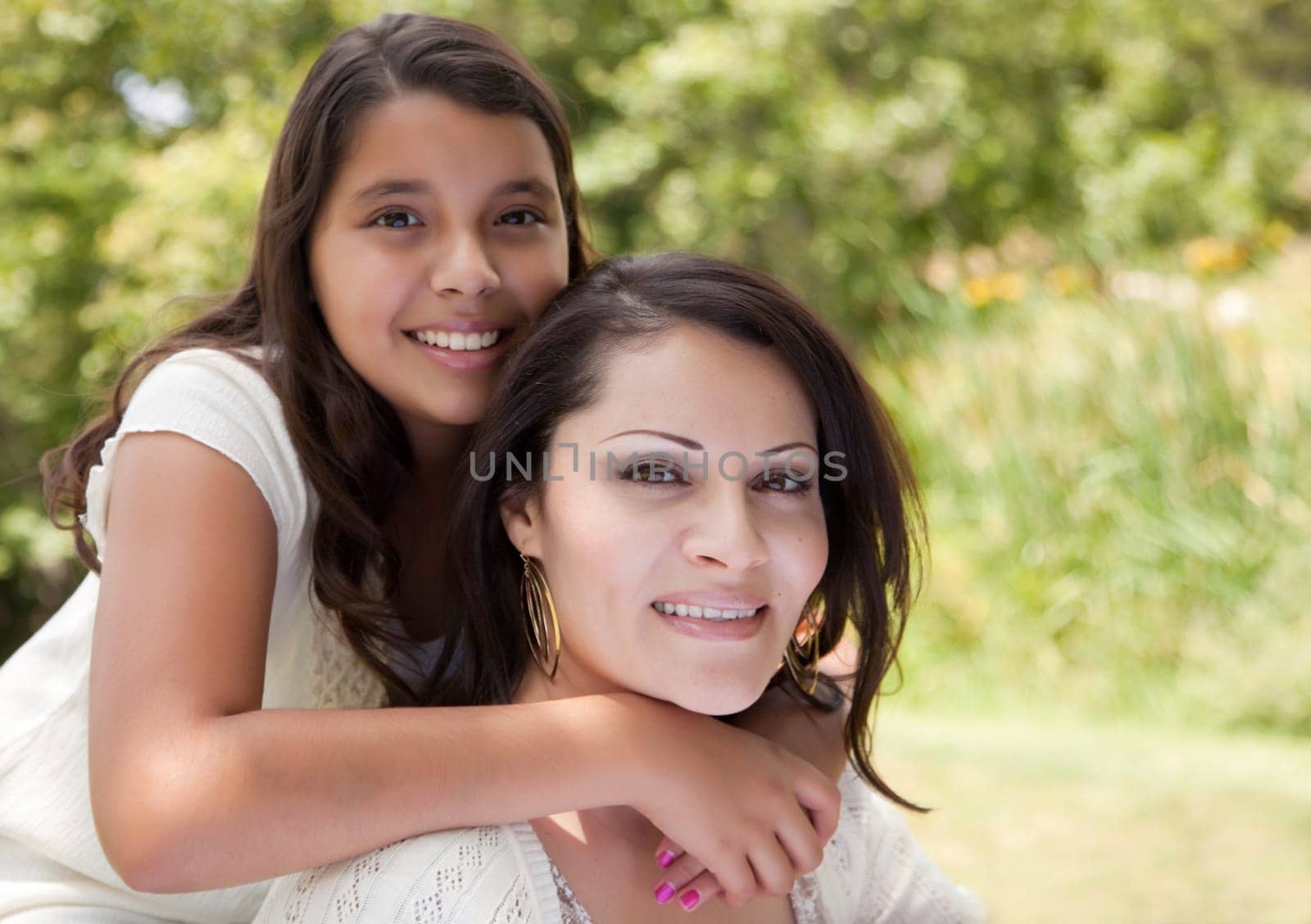 Happy Hispanic Mother and Daughter in the Park.