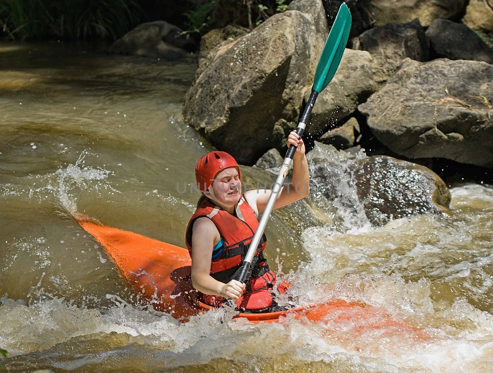 great image of a teenage facing the ordeals and challenge of white water kayaking