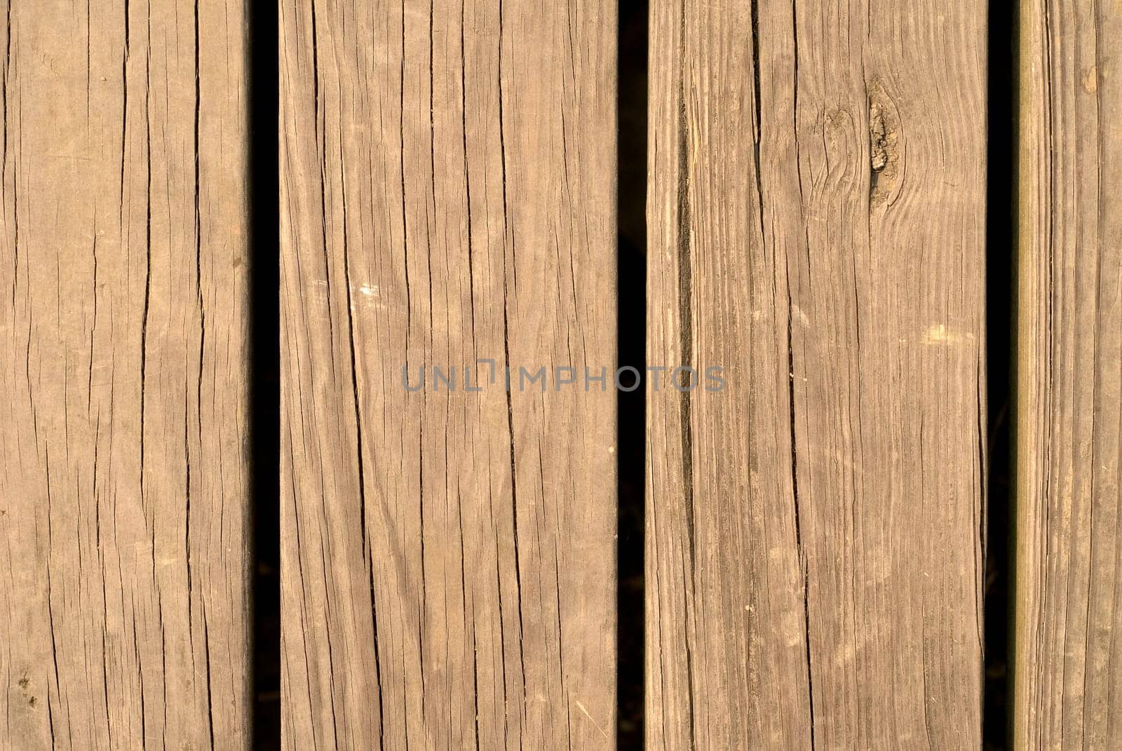 It is an old and brown wood wall.