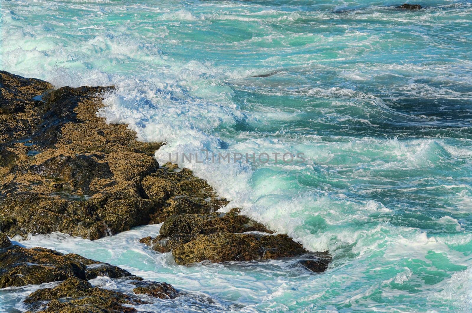 great image of strong waves splashing into the rocks