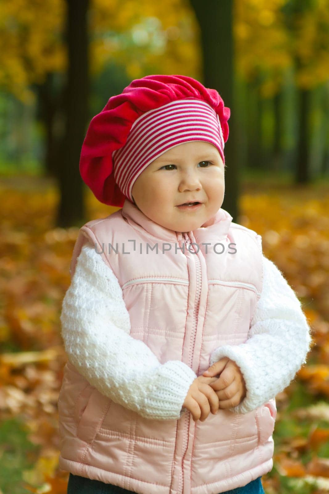 Thoughtful toddler in the autumnal city park