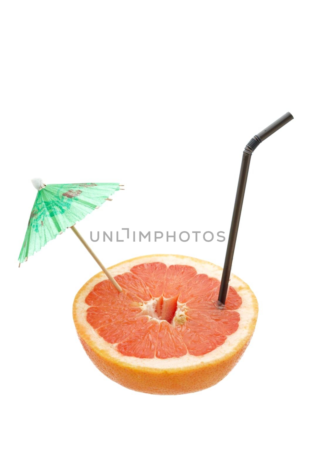 A fresh grapefruit with straw and umbrella isolated on white background. Shallow depth of field