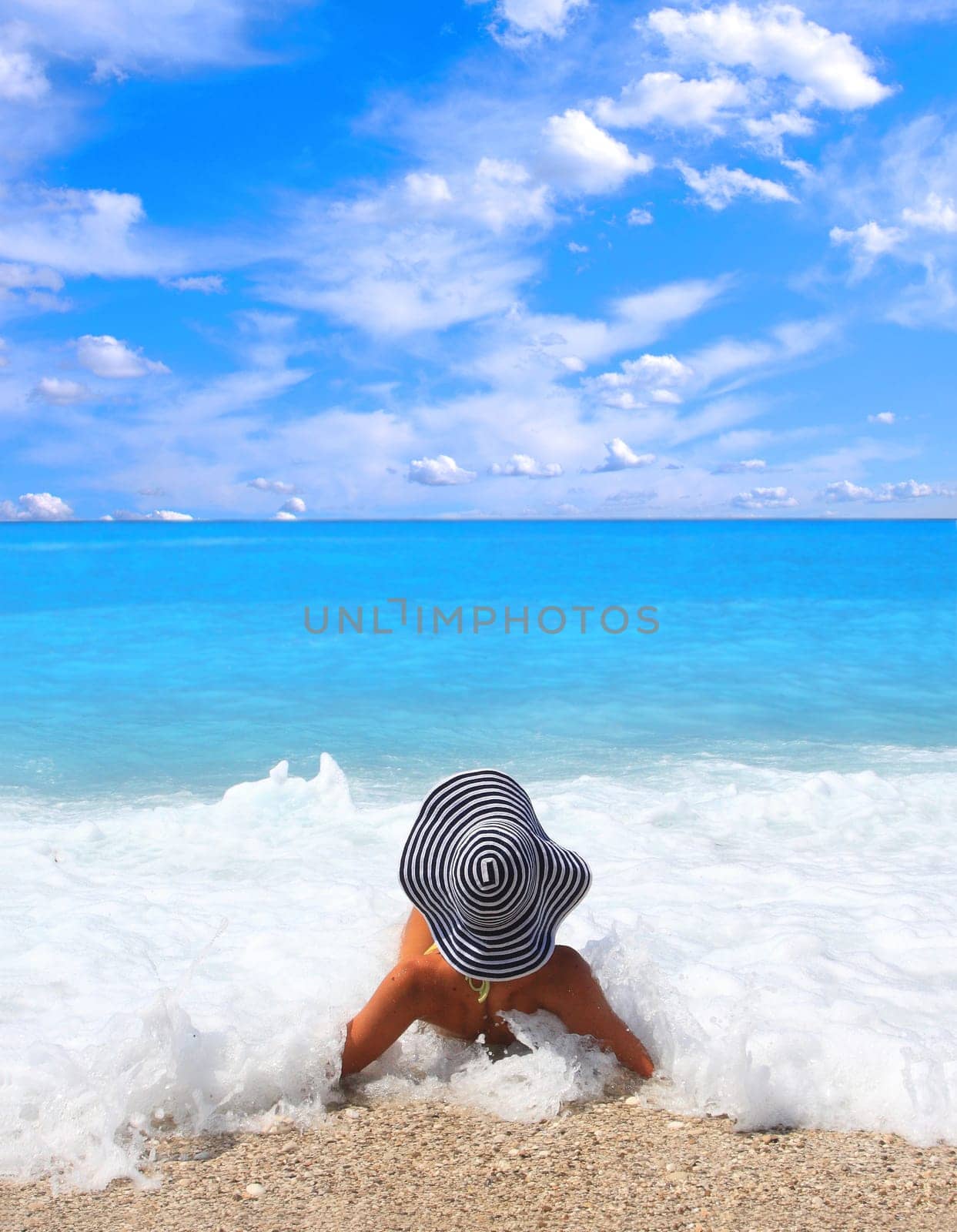 Beautiful young woman enjoying the Ionian sea in Greece