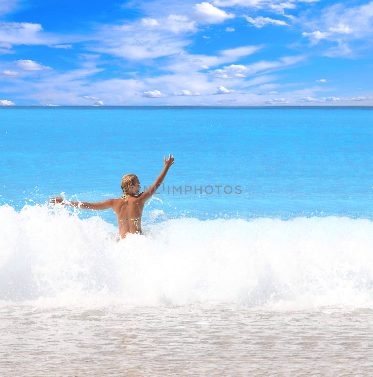 Beautiful young woman enjoying the Ionian sea in Greece