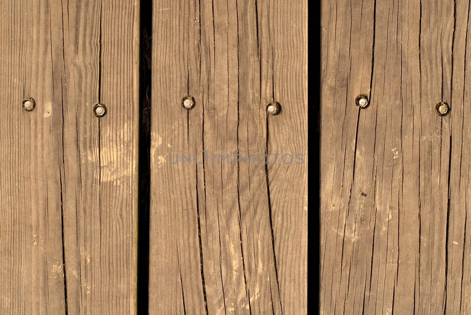 It is an old and brown wood wall.