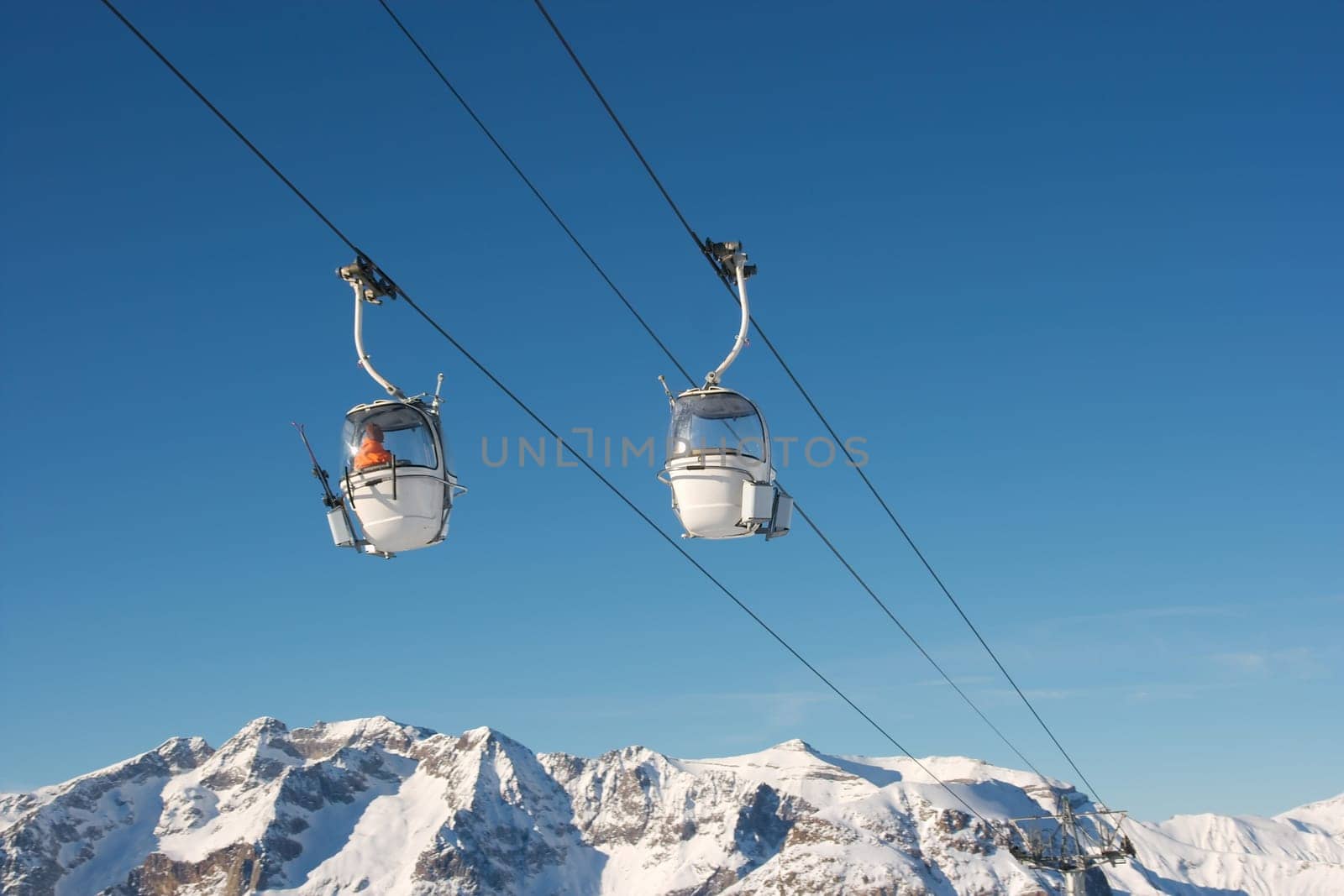 Ski lift cabins against clear blue sky