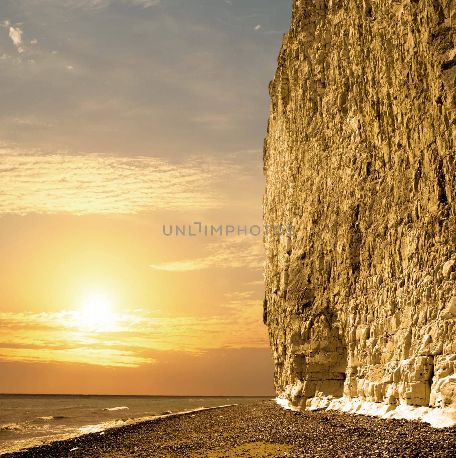 Sun setting at the coast whit large chalk cliff