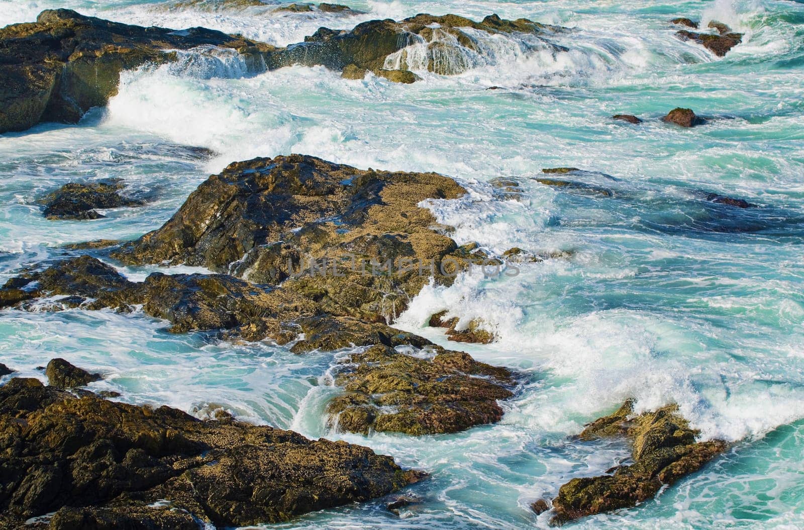 great image of strong waves splashing into the rocks