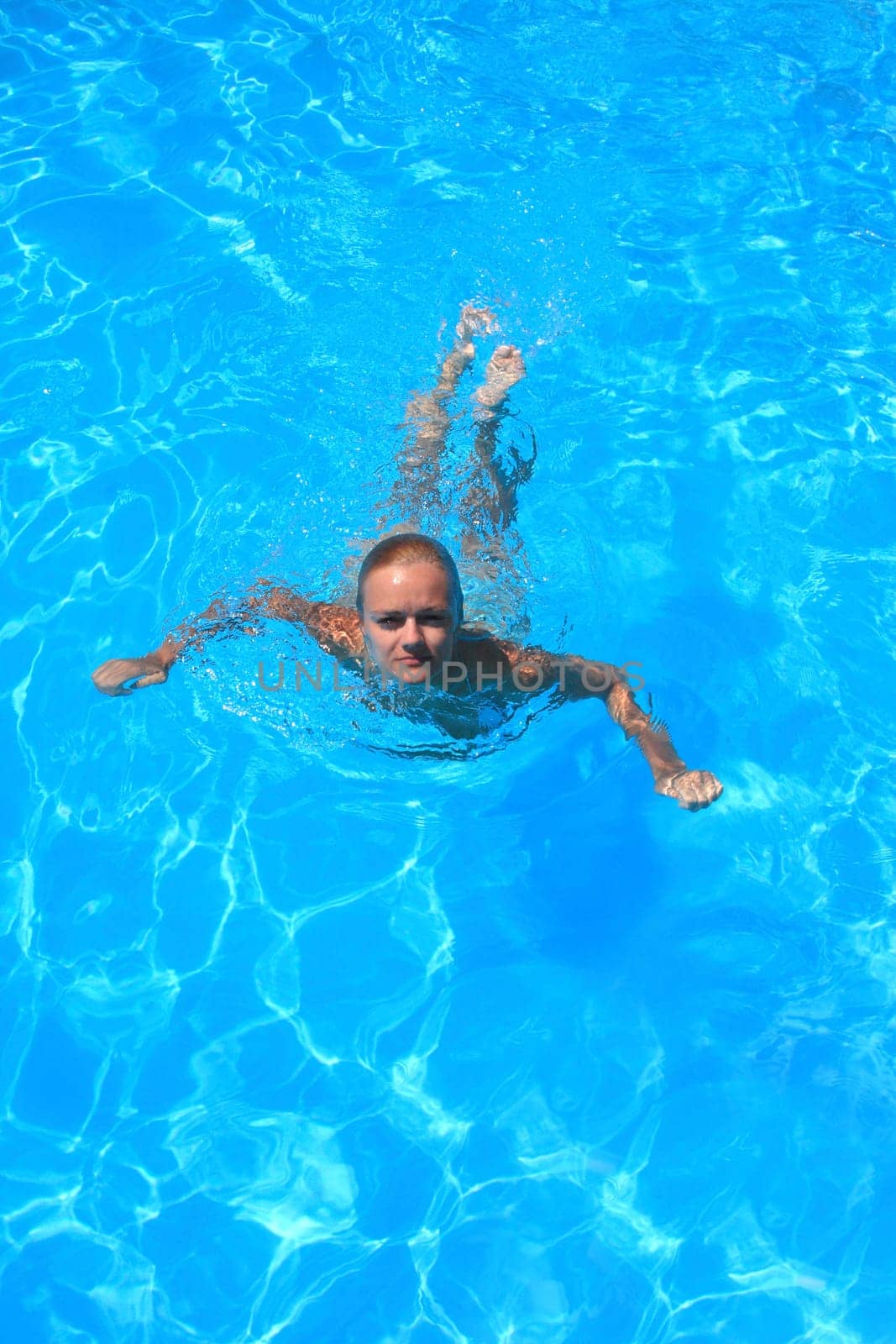 Pretty woman enjoying a swimming pool in Greece