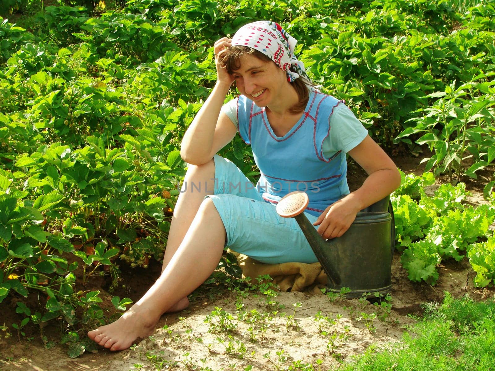woman resting near vegetable beds