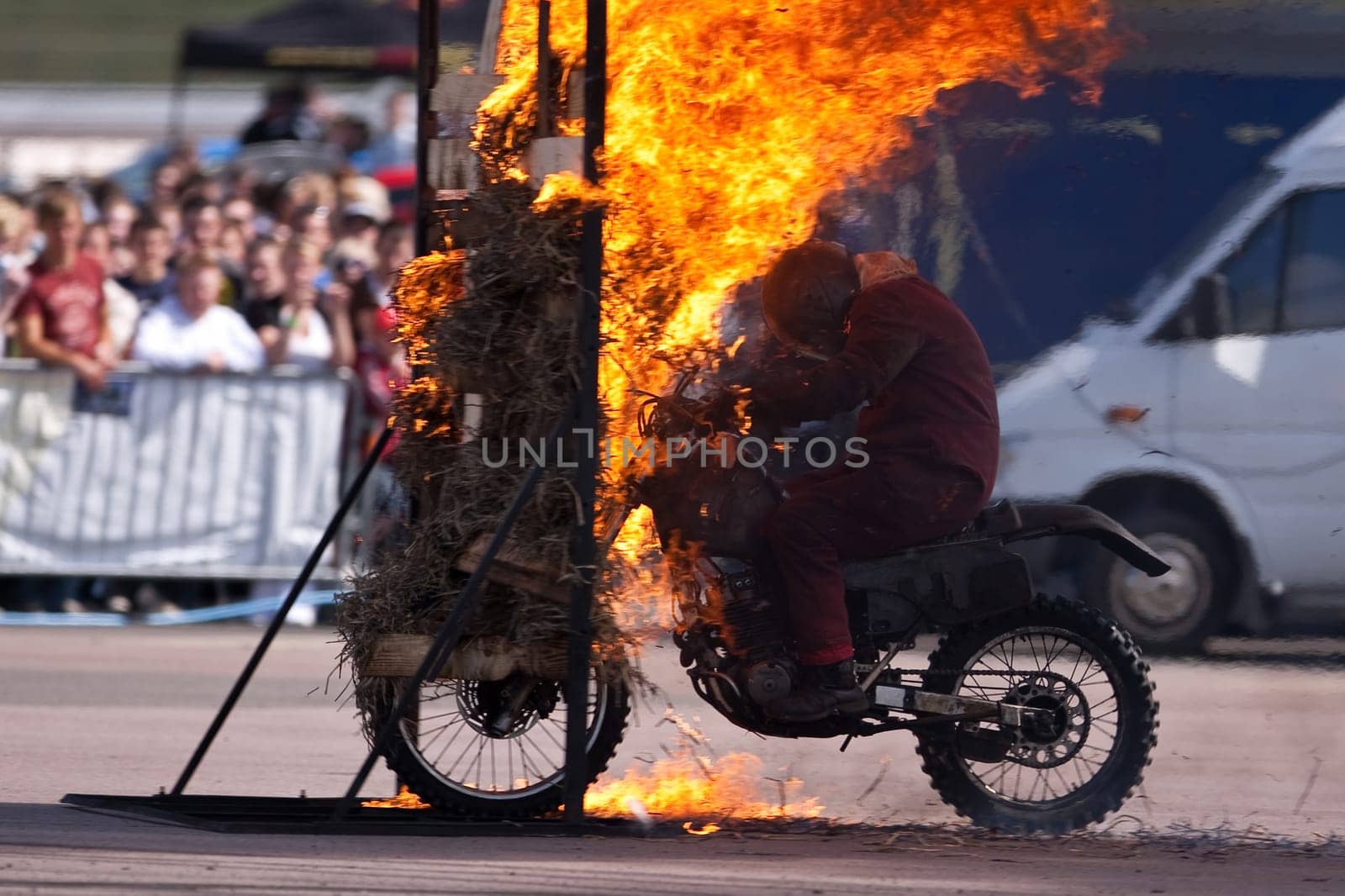Stunt rider riding through a wall of flames