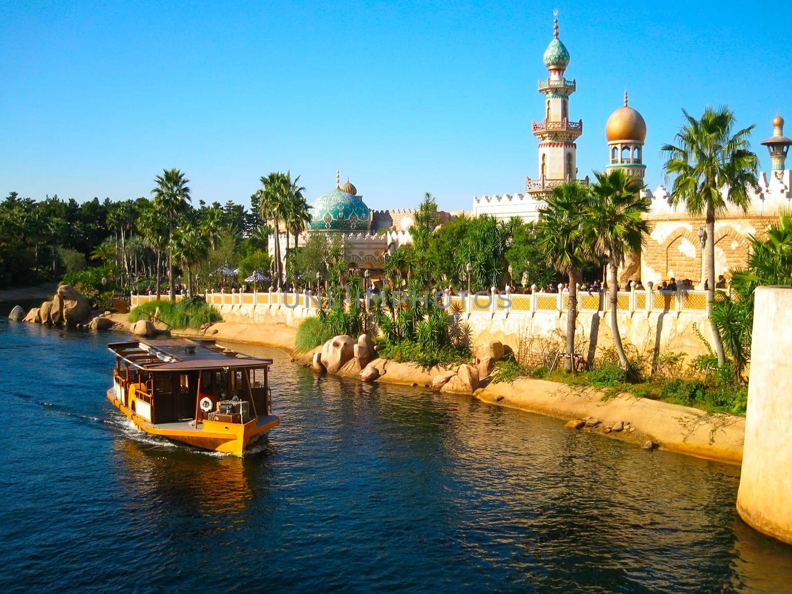 Beautiful palace with palm and ship on river