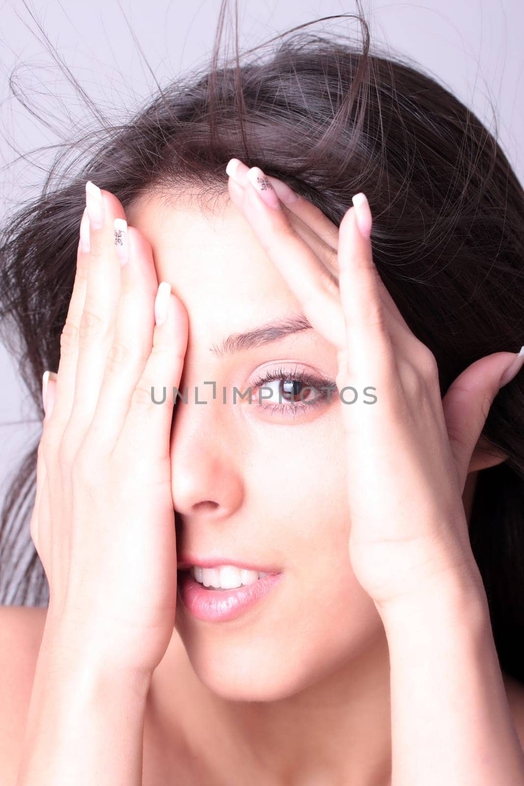 Closeup portrait of a happy young woman smiling isolated on white background
