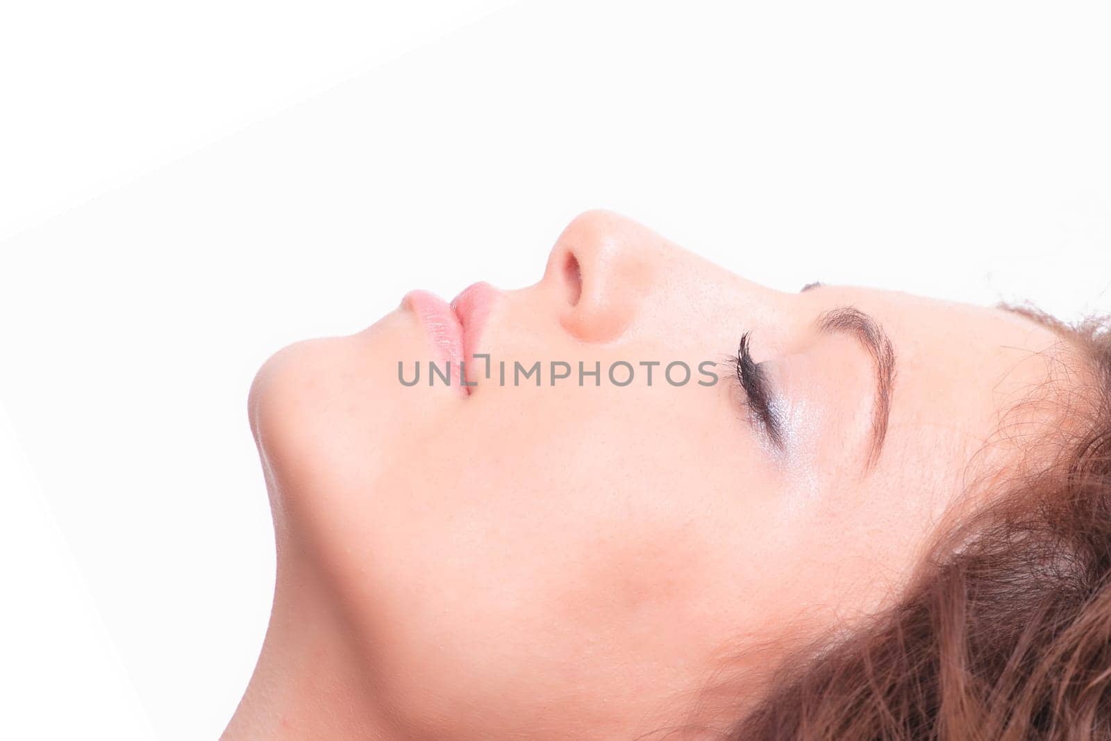 Closeup portrait of a happy young woman smiling isolated on white background