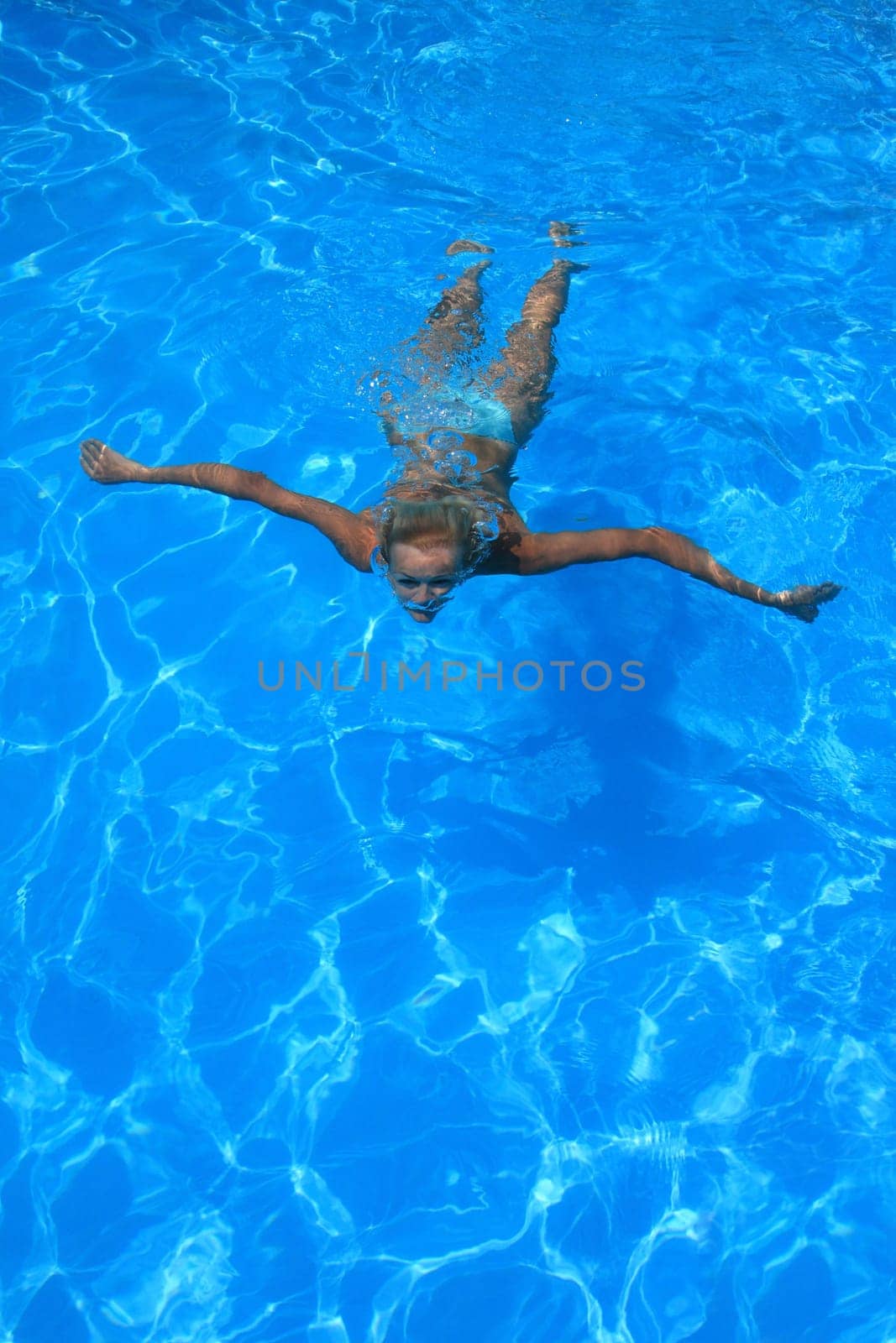 Pretty woman enjoying a swimming pool in Greece