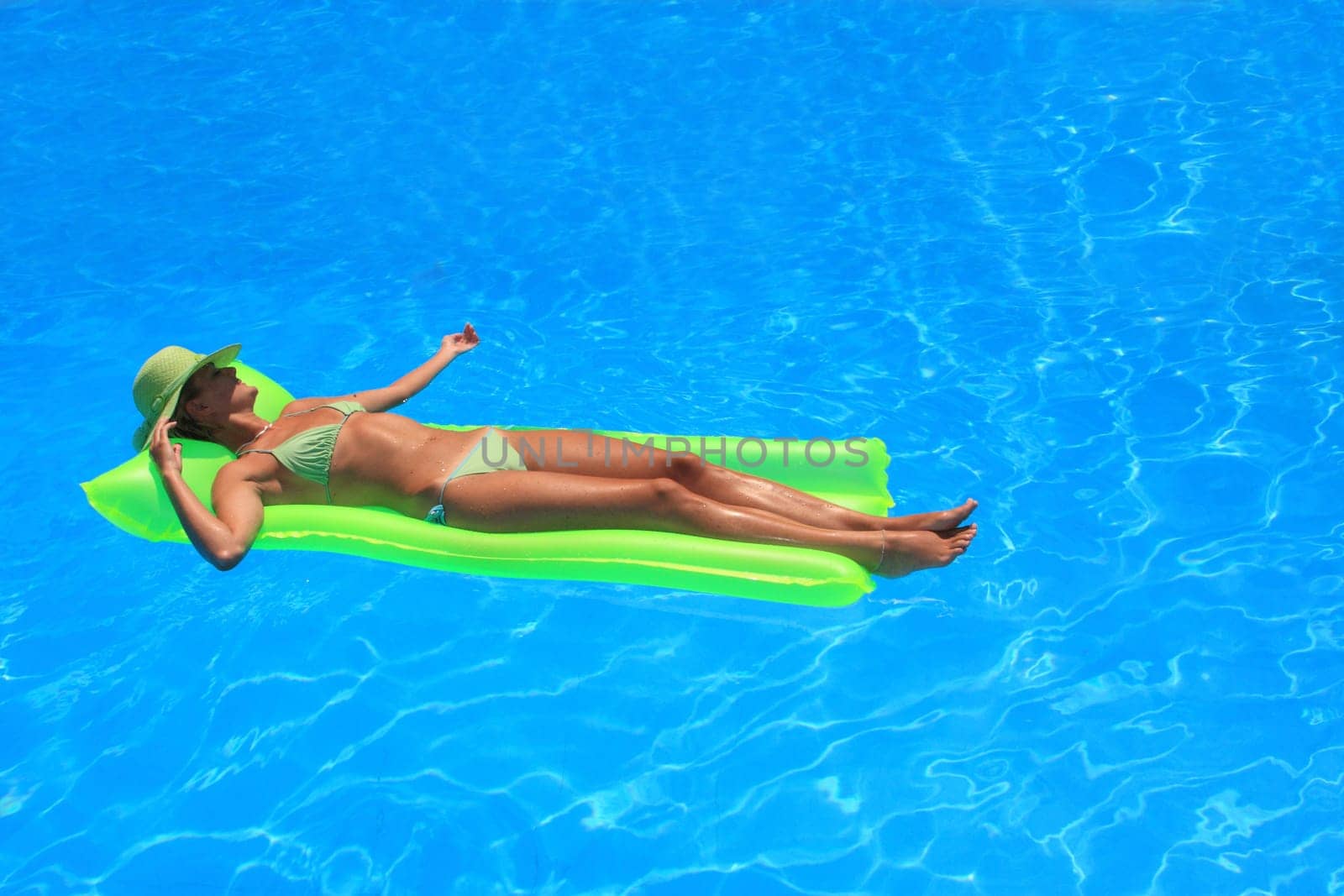 Pretty woman enjoying a swimming pool in Greece