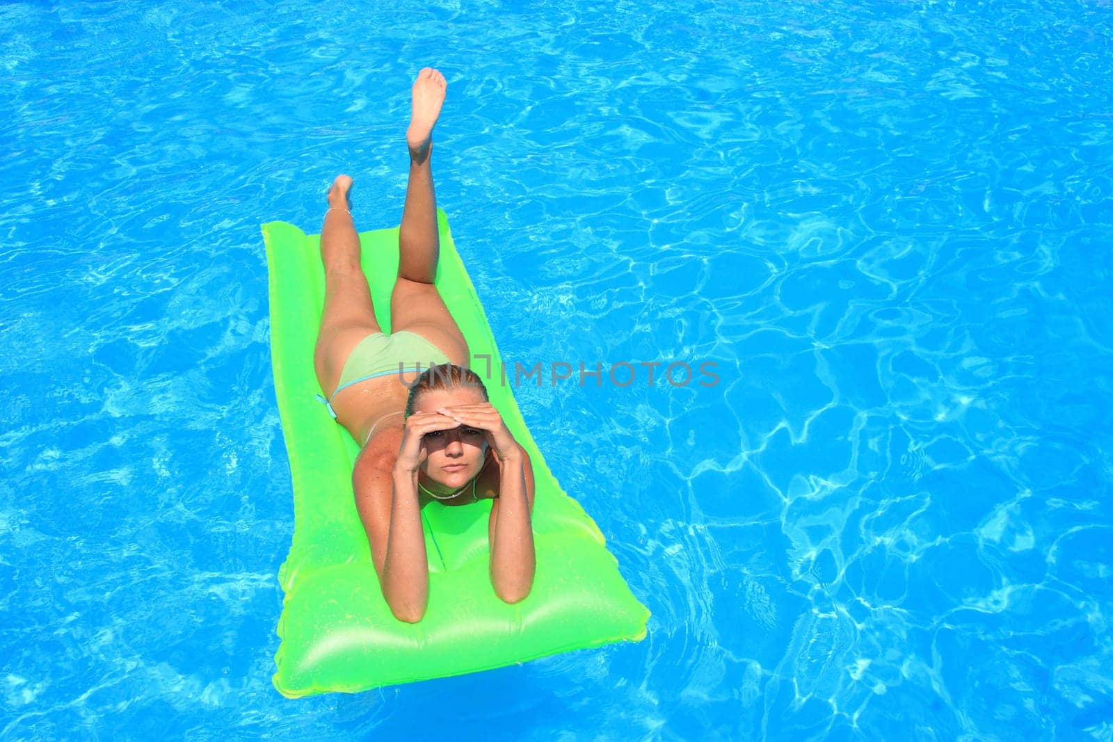 Pretty woman enjoying a swimming pool in Greece