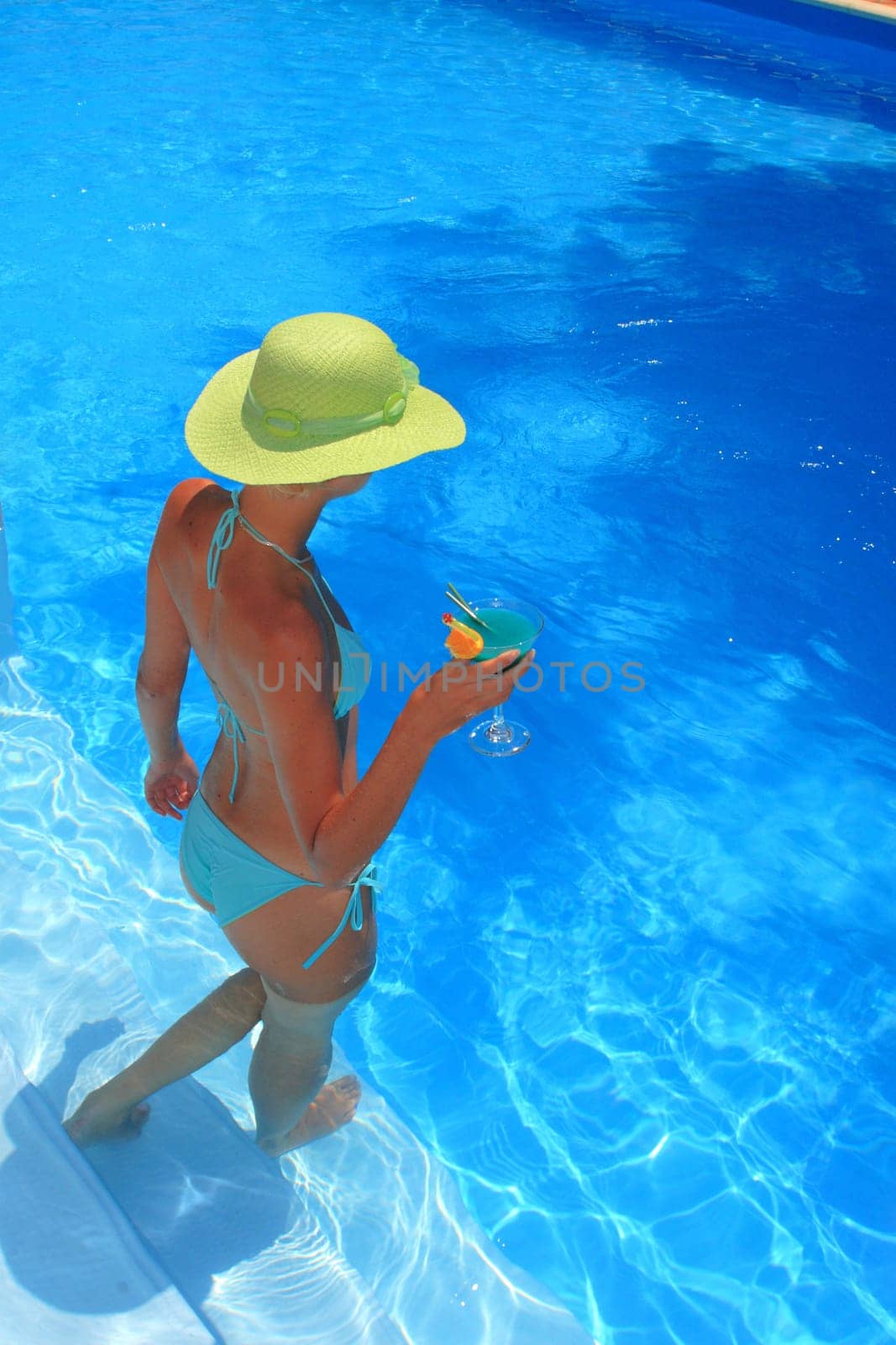 Pretty woman enjoying a swimming pool in Greece