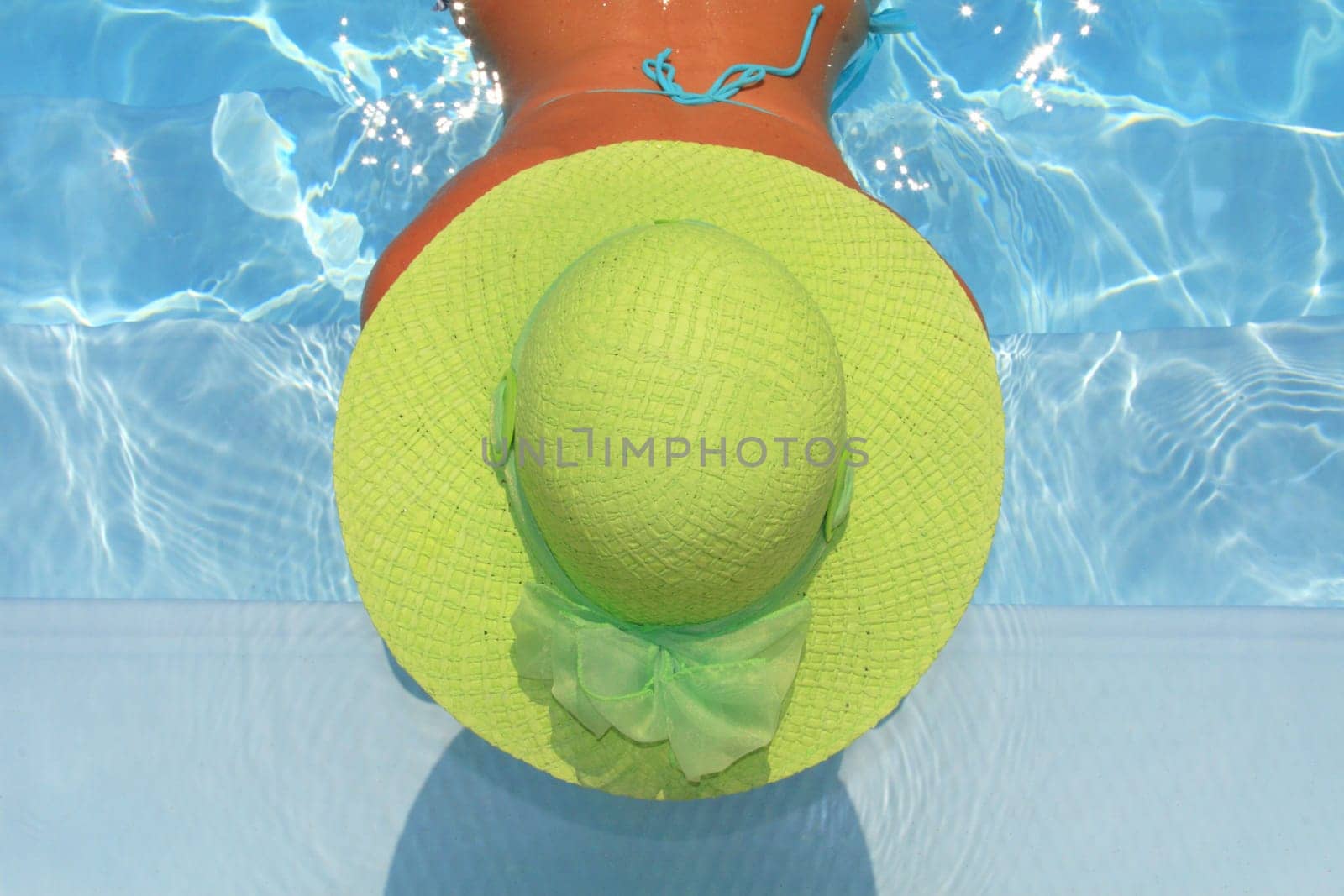 Pretty woman enjoying a swimming pool in Greece