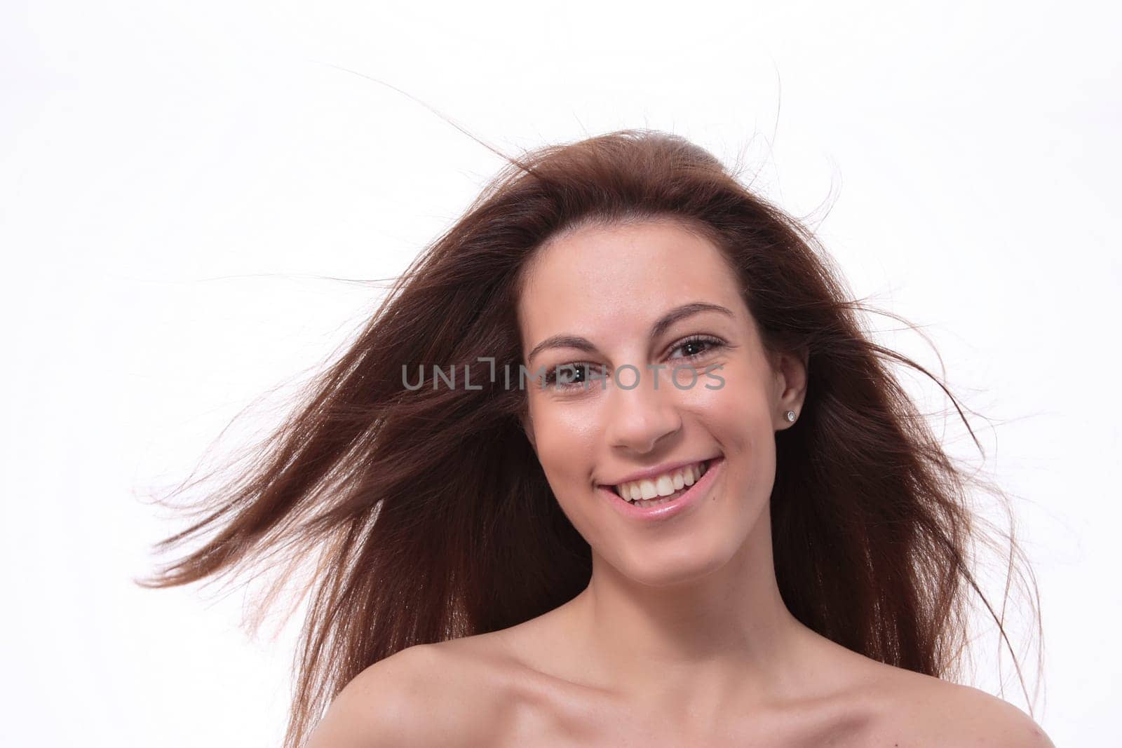 Closeup portrait of a happy young woman smiling isolated on white background